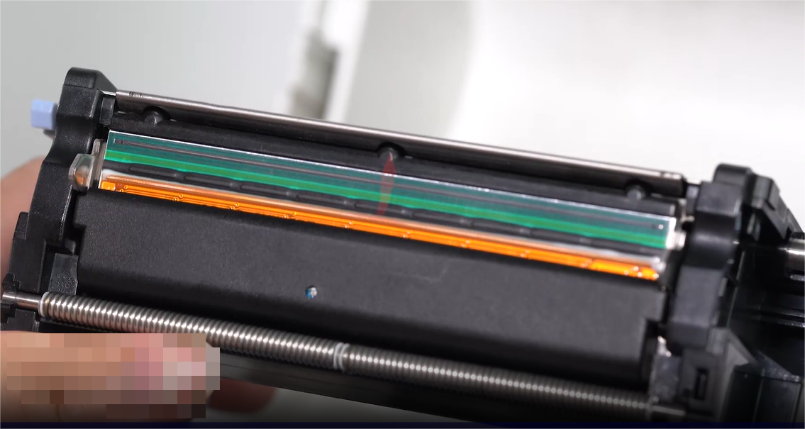 Một close-up of a person carefully cleaning an electronic component with a swab.